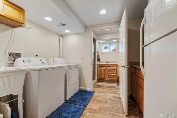 a utility room with cabinets washer and dryer