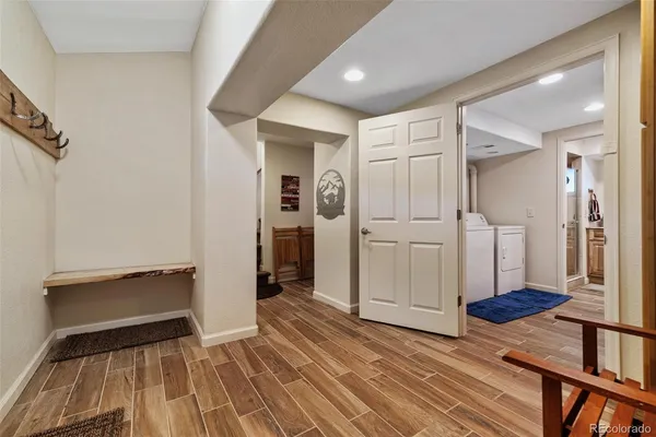 a view of a hallway view with wooden floor and staircase