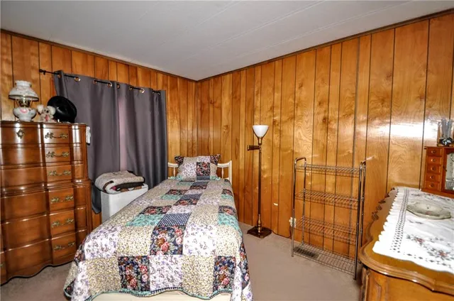 a bed room with a bed and a chair