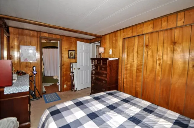 a bedroom with a bed and a dresser