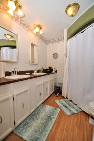 a kitchen with a sink a stove a window and cabinets