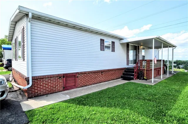 a view of a chair and table in backyard of the house