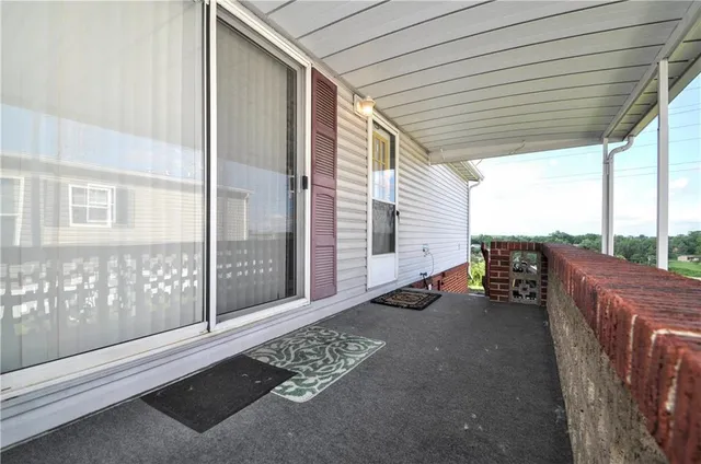 a balcony with chairs and with an outdoor view