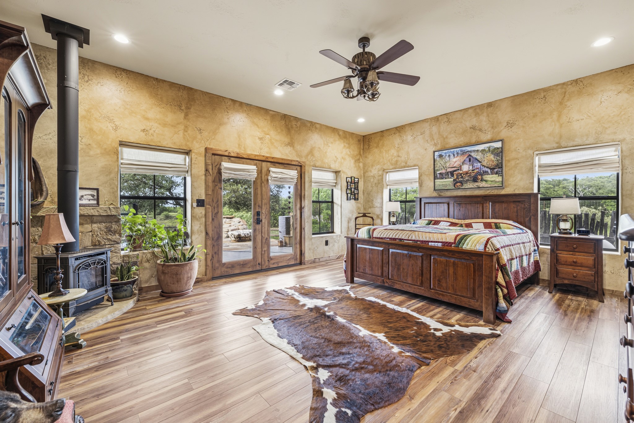 3724 Ranch Road 3347 Round Mountain, TX 78663 - Photo 11 of 40 a spacious bedroom with a bed a dresser and wooden floor