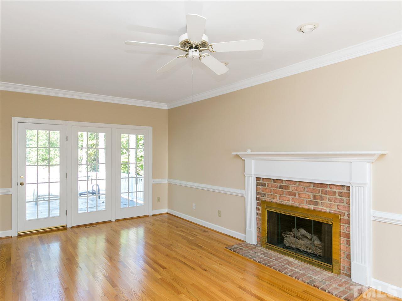 1312 Binley Place Raleigh, NC 27615 - Photo 2 of 22 a view of an empty room with a fireplace and a window