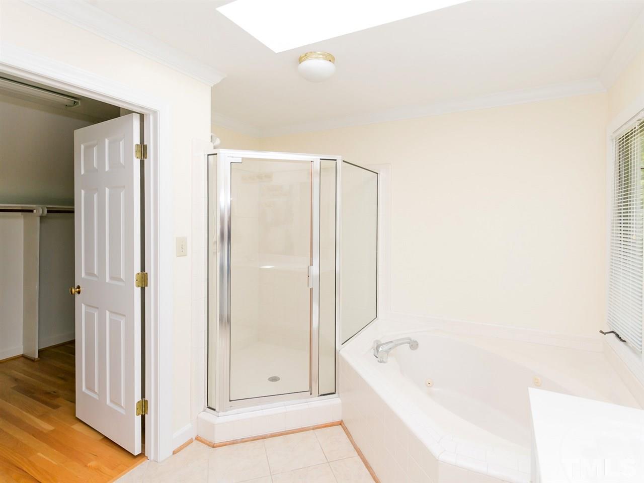 1312 Binley Place Raleigh, NC 27615 - Photo 12 of 22 a bathroom with a tub shower and sink