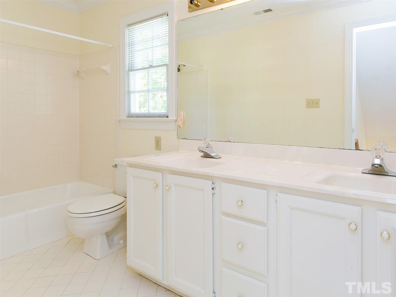 1312 Binley Place Raleigh, NC 27615 - Photo 16 of 22 a bathroom with a sink toilet and window