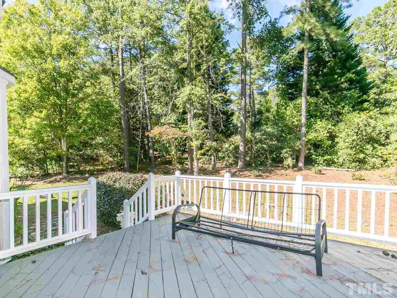 1312 Binley Place Raleigh, NC 27615 - Photo 18 of 22 a view of a wooden deck with a yard and wooden fence