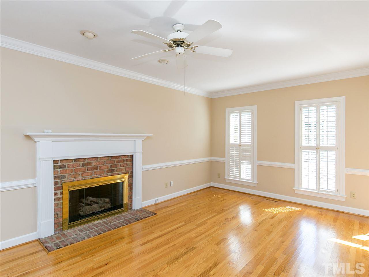 1312 Binley Place Raleigh, NC 27615 - Photo 3 of 22 an empty room with windows and fireplace