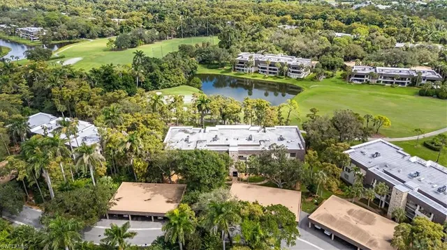 an aerial view of a house with a garden and lake view