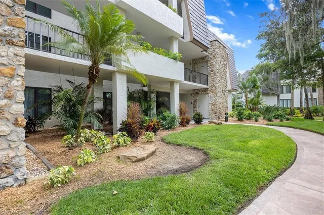 a view of a house with a yard and plants