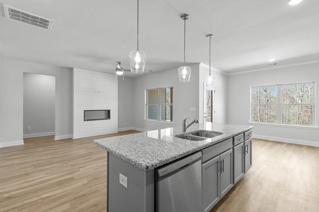 154 Greenview Court Homer, GA 30547 - Photo 13 of 44 a kitchen with granite countertop kitchen island a sink appliances and a counter space