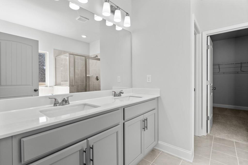 154 Greenview Court Homer, GA 30547 - Photo 28 of 44 a bathroom with a sink a large mirror and a shower