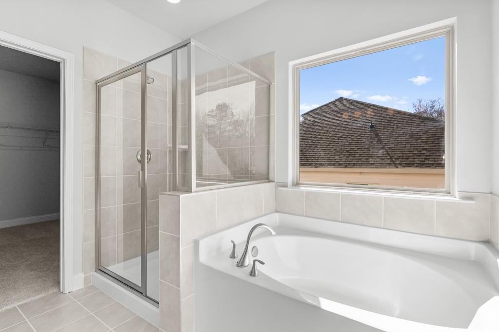 154 Greenview Court Homer, GA 30547 - Photo 29 of 44 a bathroom with a bathtub and a shower