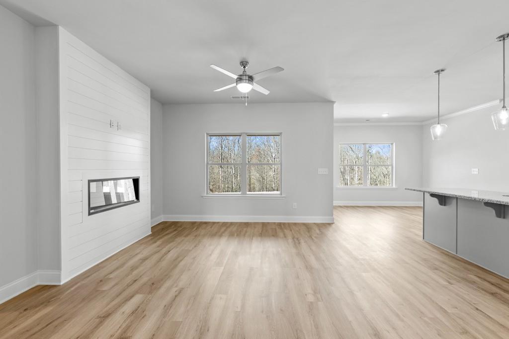 154 Greenview Court Homer, GA 30547 - Photo 5 of 44 a view of an empty room with a window and wooden floor