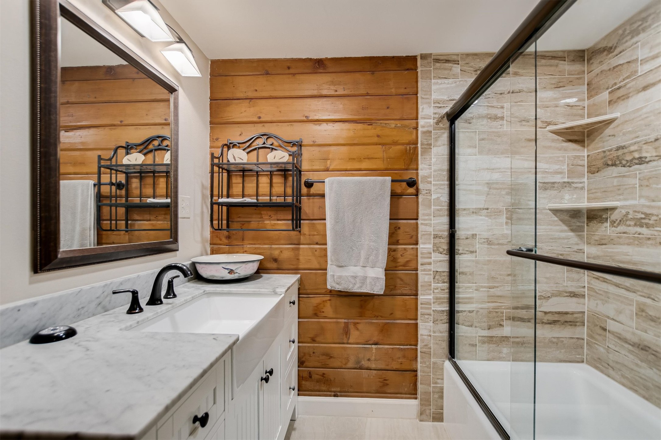 12711 Rr, Unit 12 Wimberley, TX 78676 - Photo 9 of 20 The updated primary bathroom features modern fixtures and finishes that complement the home’s natural wood tones