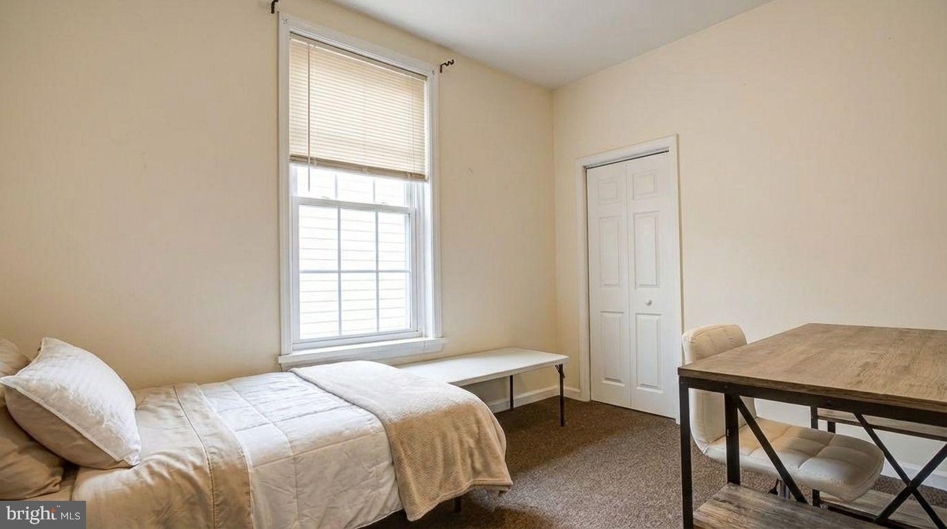 1920 North 18th Street, Unit 1 Philadelphia, PA 19121 - Photo 6 of 12 a bedroom with a bed and a window