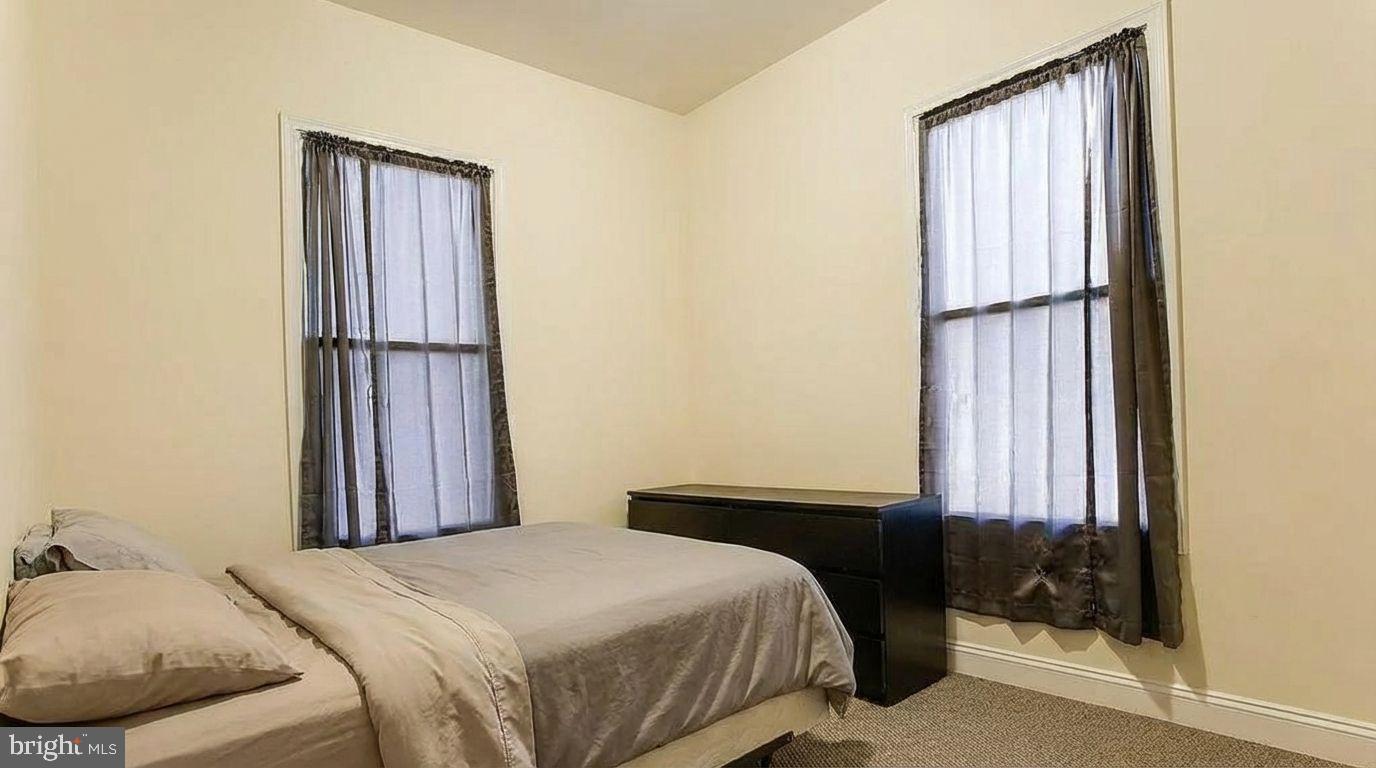 1920 North 18th Street, Unit 1 Philadelphia, PA 19121 - Photo 9 of 12 a bedroom with a bed and a window