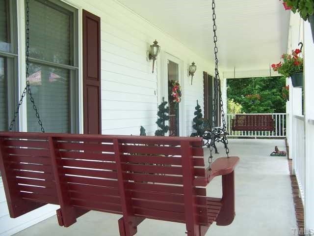 2431 Flat River Church Road Roxboro, NC 27574 - Photo 2 of 12 a view of a balcony with a bench