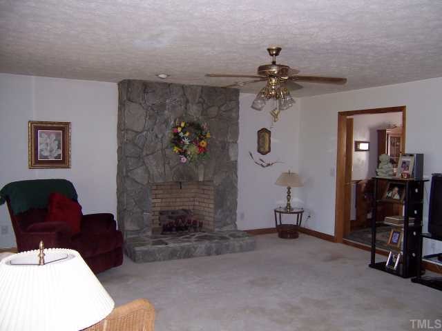 2431 Flat River Church Road Roxboro, NC 27574 - Photo 3 of 12 a living room with furniture and a fireplace