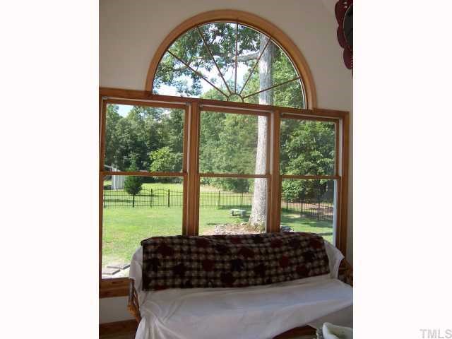 2431 Flat River Church Road Roxboro, NC 27574 - Photo 8 of 12 a bed sitting in a bedroom next to a window