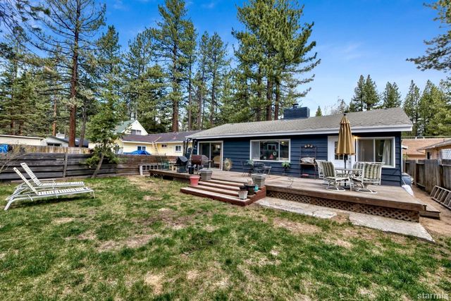 a front view of a house with a yard table and chairs