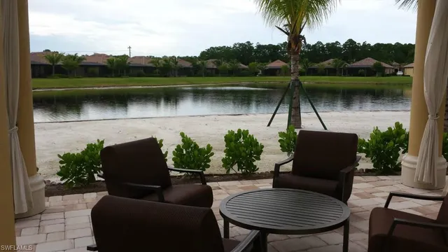 a view of a lake with a table and a potted plant