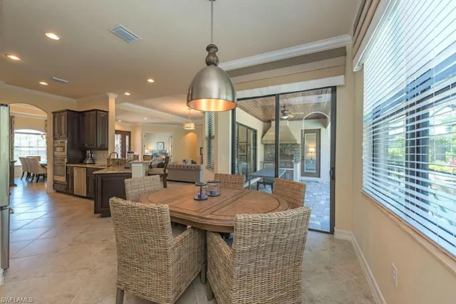 a dining hall with couches a flat tv screen and a dining table with garden view