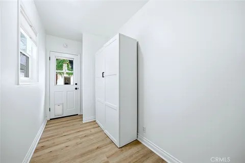 a view of a hallway with wooden floor