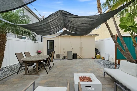 a backyard of a house with table and chairs