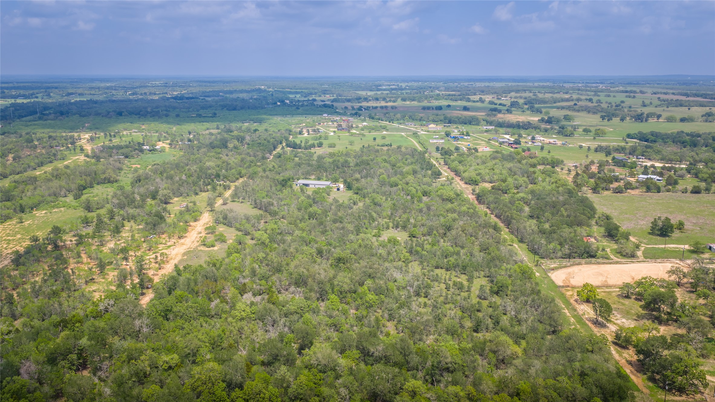 4082 Old Colony Line Road Lockhart, TX 78644 - Photo 29 of 40 Vast natural acreage, perfect for development or a private estate, with distant structures dotting the landscape.