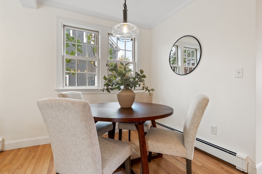 108 Warren Street Arlington, MA 02474 - Photo 11 of 42 a view of a dining room with furniture and a chandelier