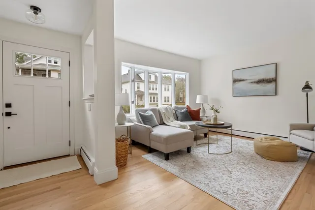 a living room with furniture and wooden floor