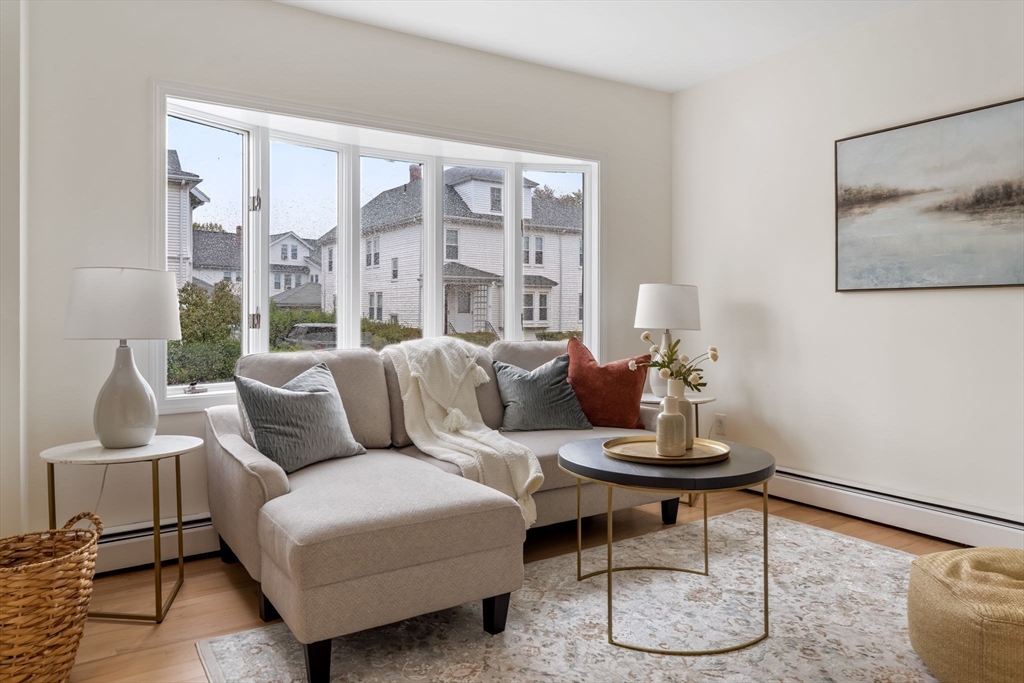 108 Warren Street Arlington, MA 02474 - Photo 19 of 42 a living room with furniture and a large window
