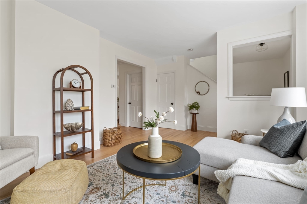 108 Warren Street Arlington, MA 02474 - Photo 21 of 42 a living room with furniture a lamp and a table