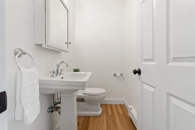 a bathroom with a sink toilet and a mirror