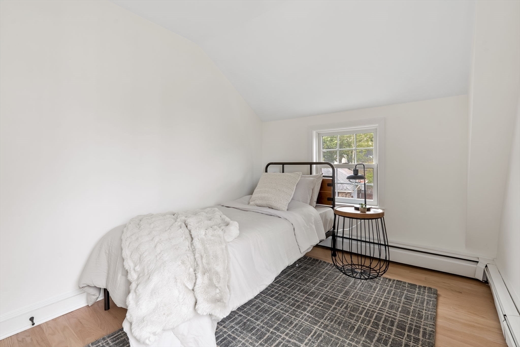 108 Warren Street Arlington, MA 02474 - Photo 30 of 42 a bedroom with a bed and a window