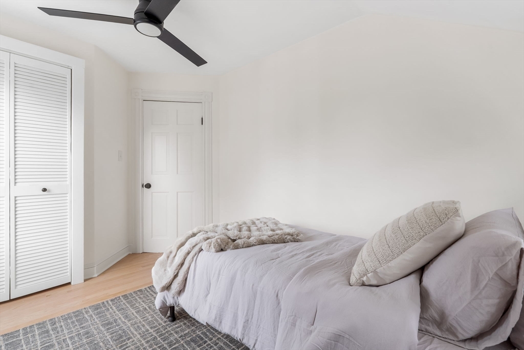 108 Warren Street Arlington, MA 02474 - Photo 31 of 42 a bedroom with a bed and a couch