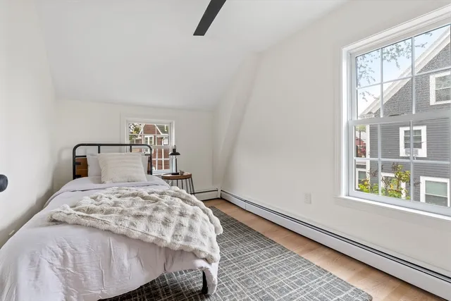 a bedroom with a bed a window and walk in closet