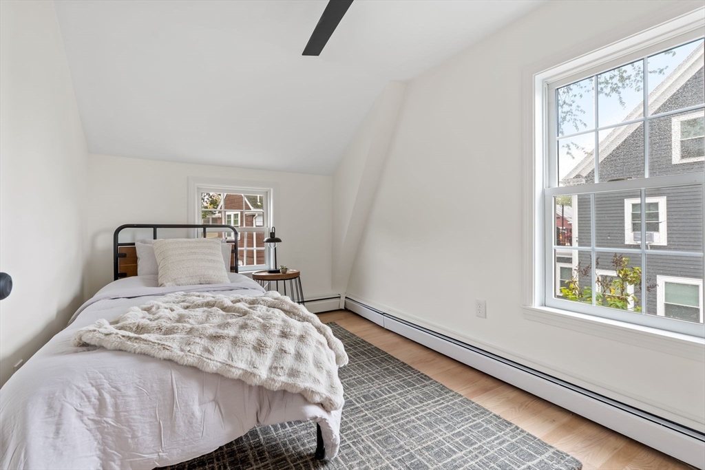 108 Warren Street Arlington, MA 02474 - Photo 36 of 42 a bedroom with a bed a window and walk in closet