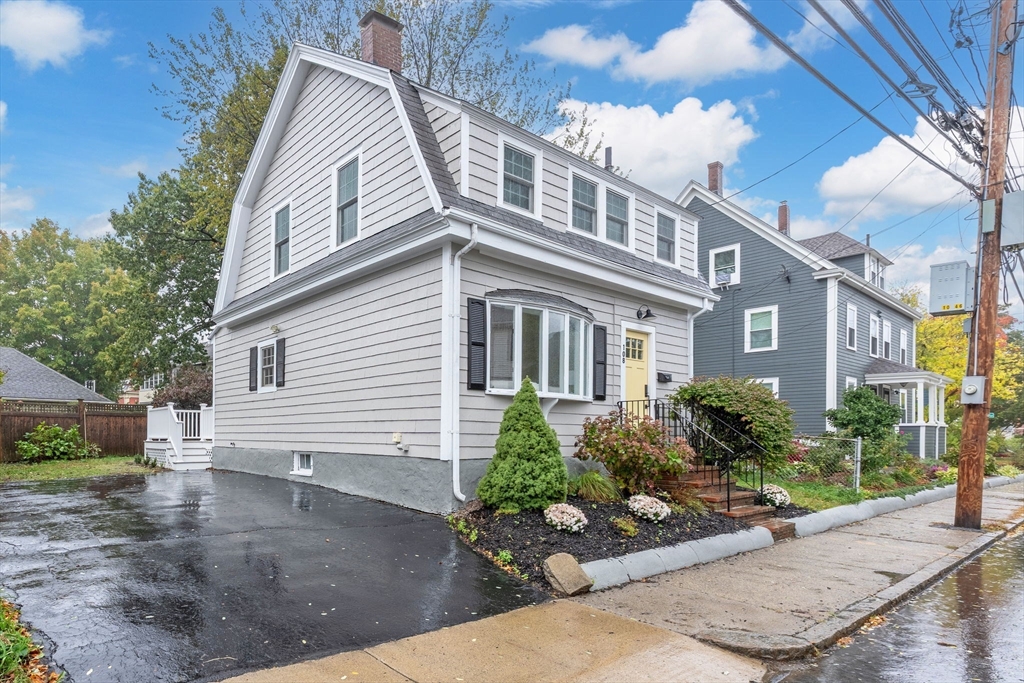 108 Warren Street Arlington, MA 02474 - Photo 40 of 42 a view of a white house next to a yard