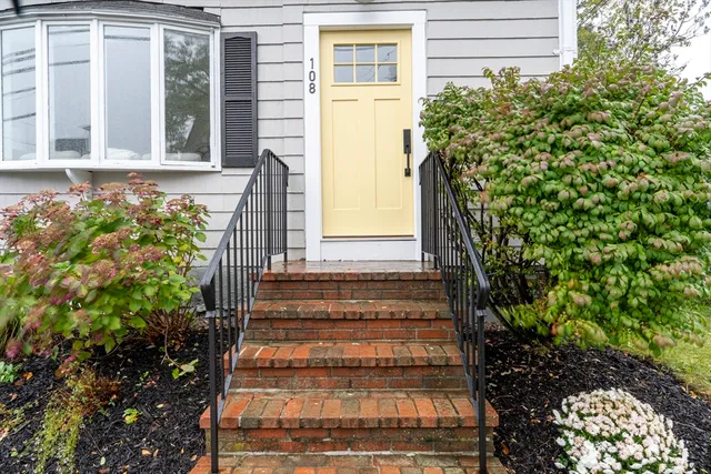 a view of a house with potted plants
