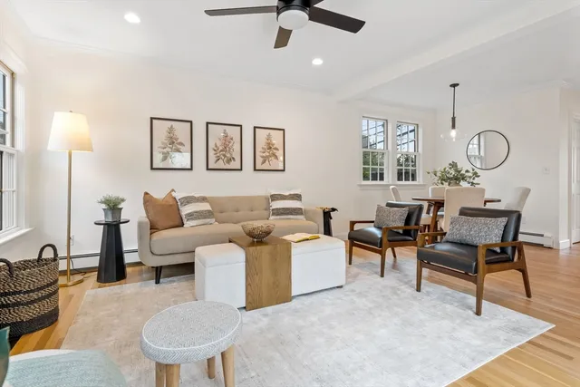 a living room with furniture a rug and a window
