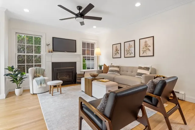 a living room with furniture a fireplace and a flat screen tv