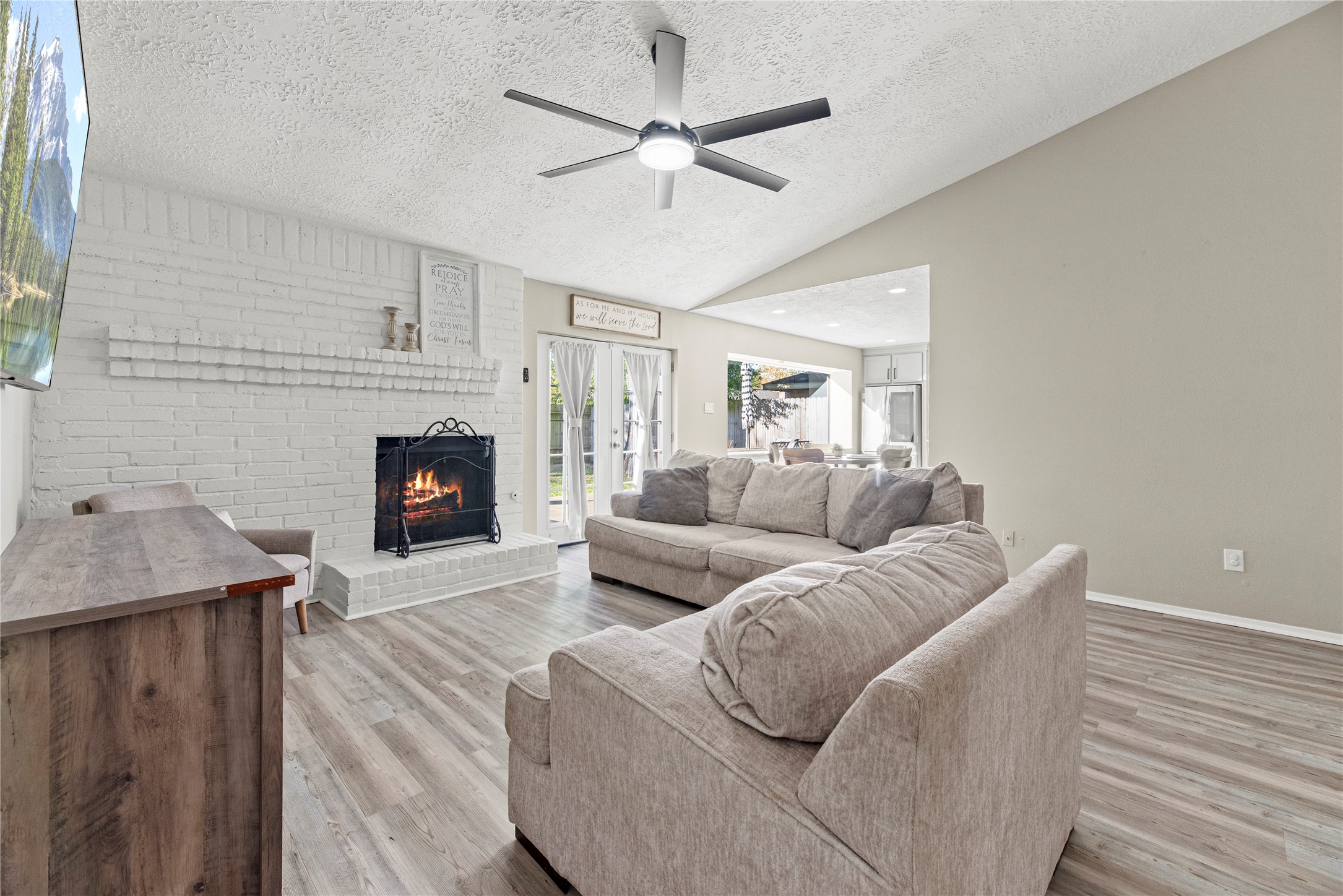 3519 Acorn Way Lane Spring, TX 77389 - Photo 4 of 15 a living room with furniture a fireplace and a ceiling fan