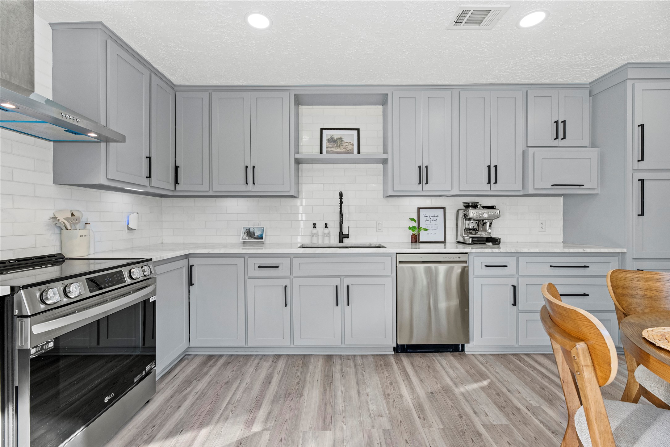 3519 Acorn Way Lane Spring, TX 77389 - Photo 5 of 15 a kitchen with cabinets stainless steel appliances a sink and wooden floor