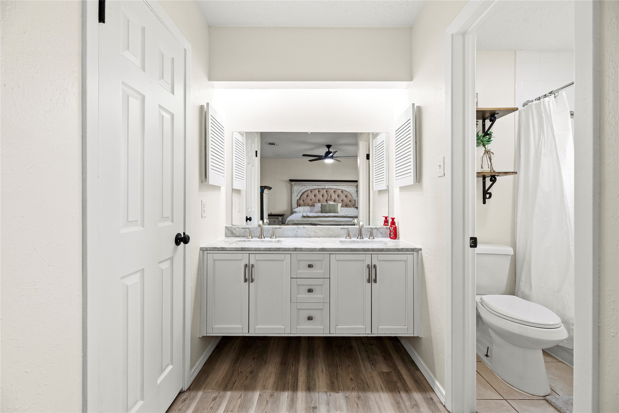 3519 Acorn Way Lane Spring, TX 77389 - Photo 7 of 15 a bathroom with a sink a toilet and a large mirror