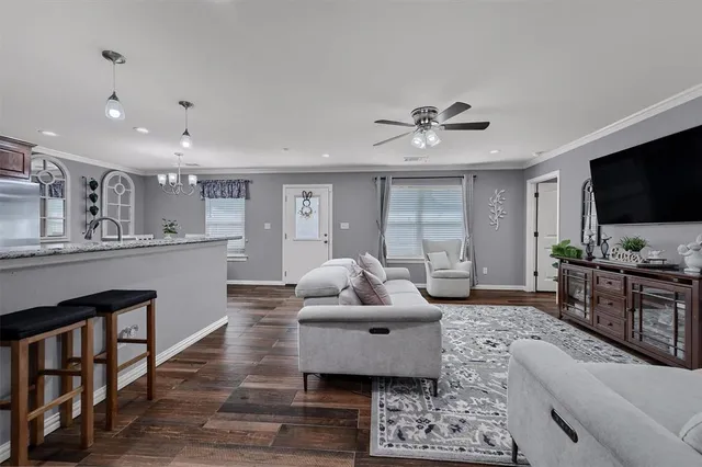 a living room with furniture and a flat screen tv