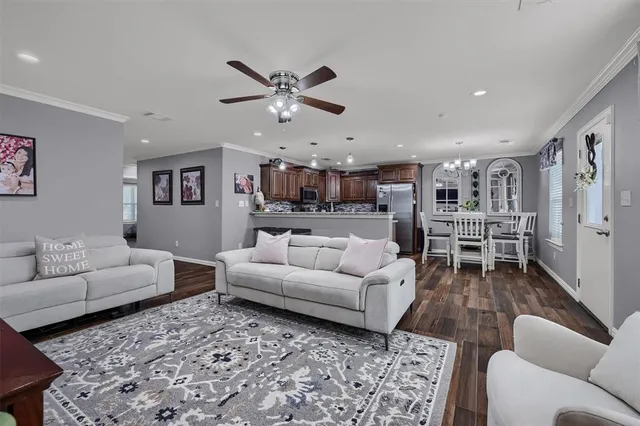 a living room with furniture and kitchen view
