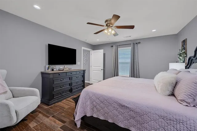 a bedroom with a bed and a flat screen tv